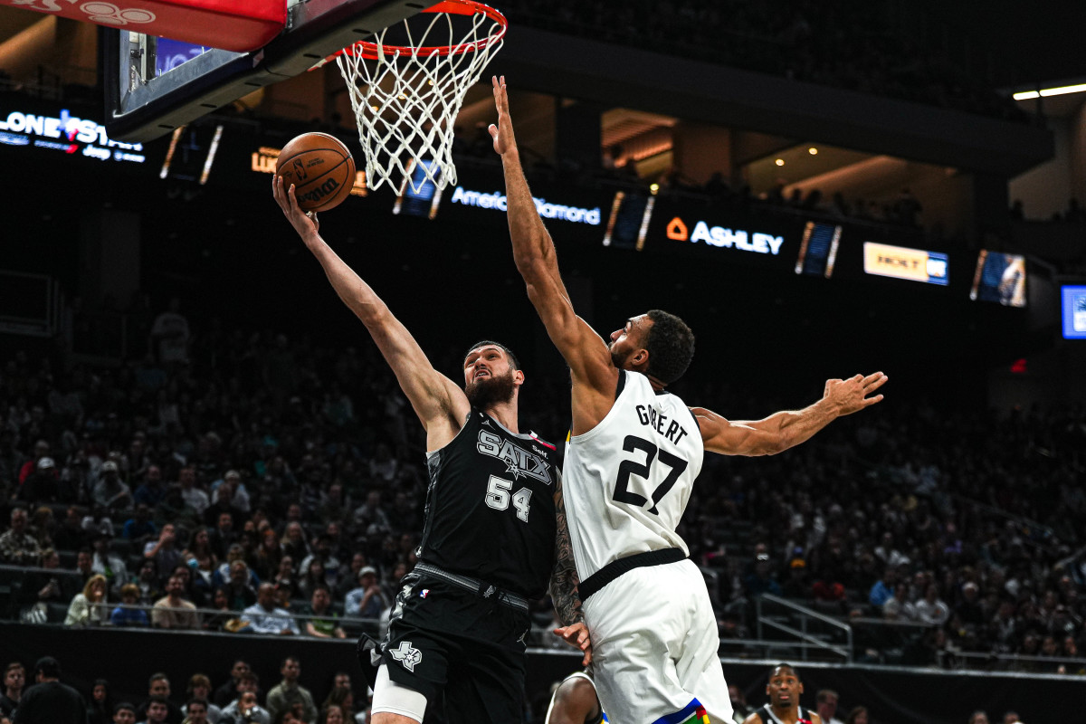 San Antonio Spurs forward Sandro Mamukelashvili (54) shoots past Minnesota Timberwolves center Rudy Gobert (27) during the game at the Moody Center on Saturday, April 8, 2023 in Austin.